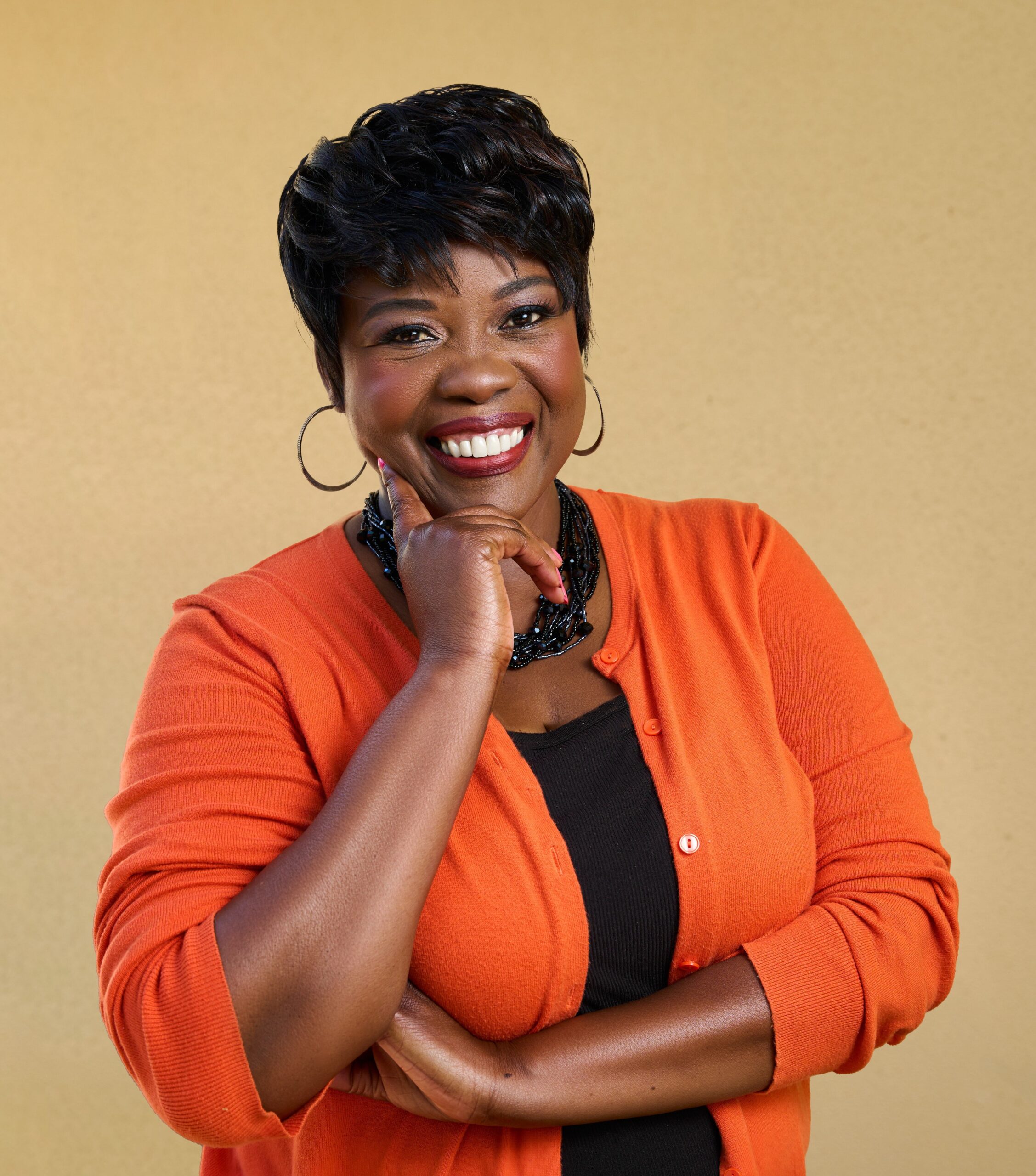 Commissioner Melissa P. Dunn, (Lauderhill) dressed in a black top with an bright orange sweater and a set of black beads around her neck.